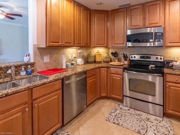 a kitchen with a sink stove and microwave
