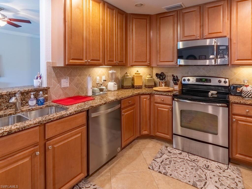 9115 Napoli Court, Unit 101 Naples, FL 34113 - Photo 8 of 49 a kitchen with a sink stove and microwave
