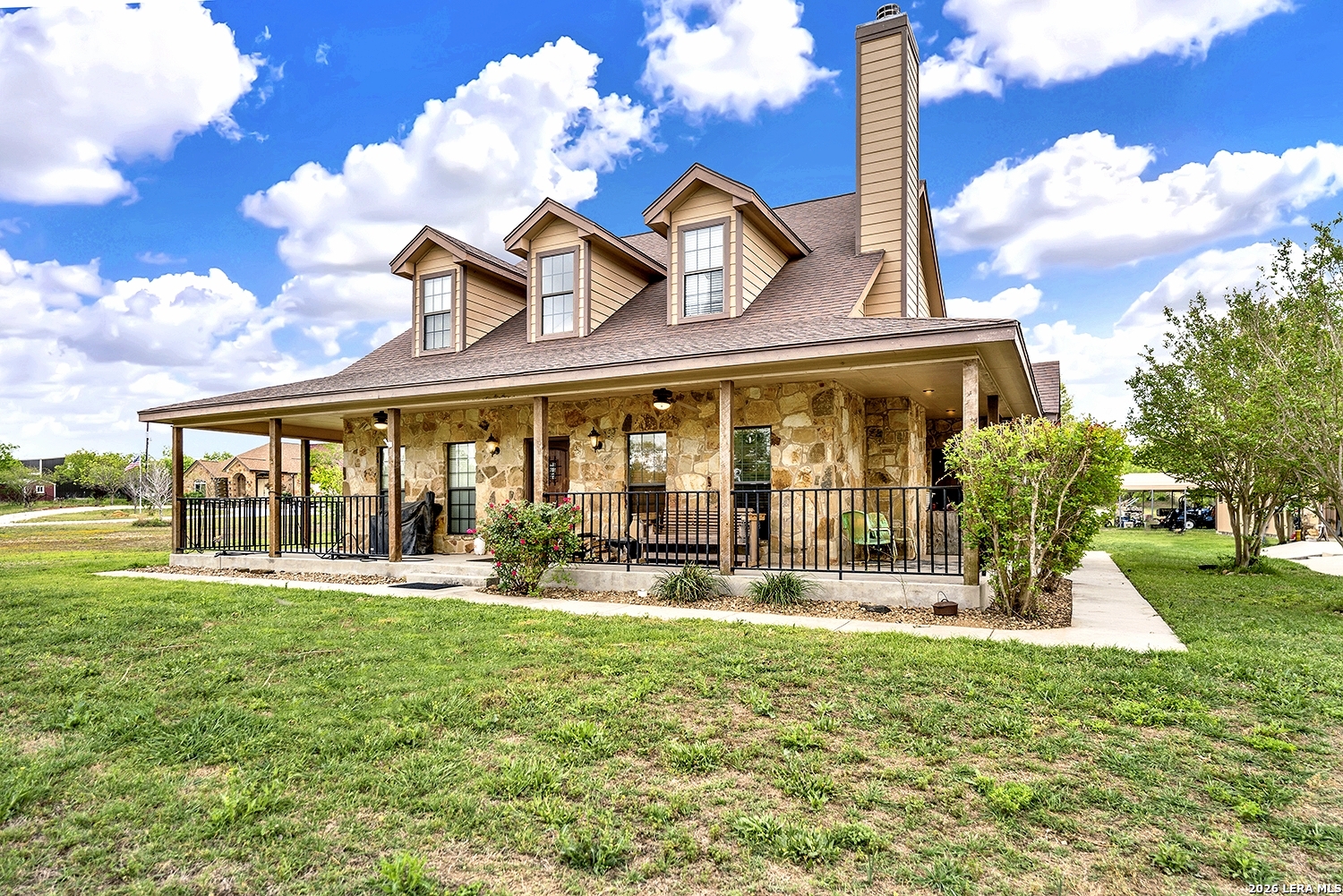 a view of a house with a yard patio and fire pit