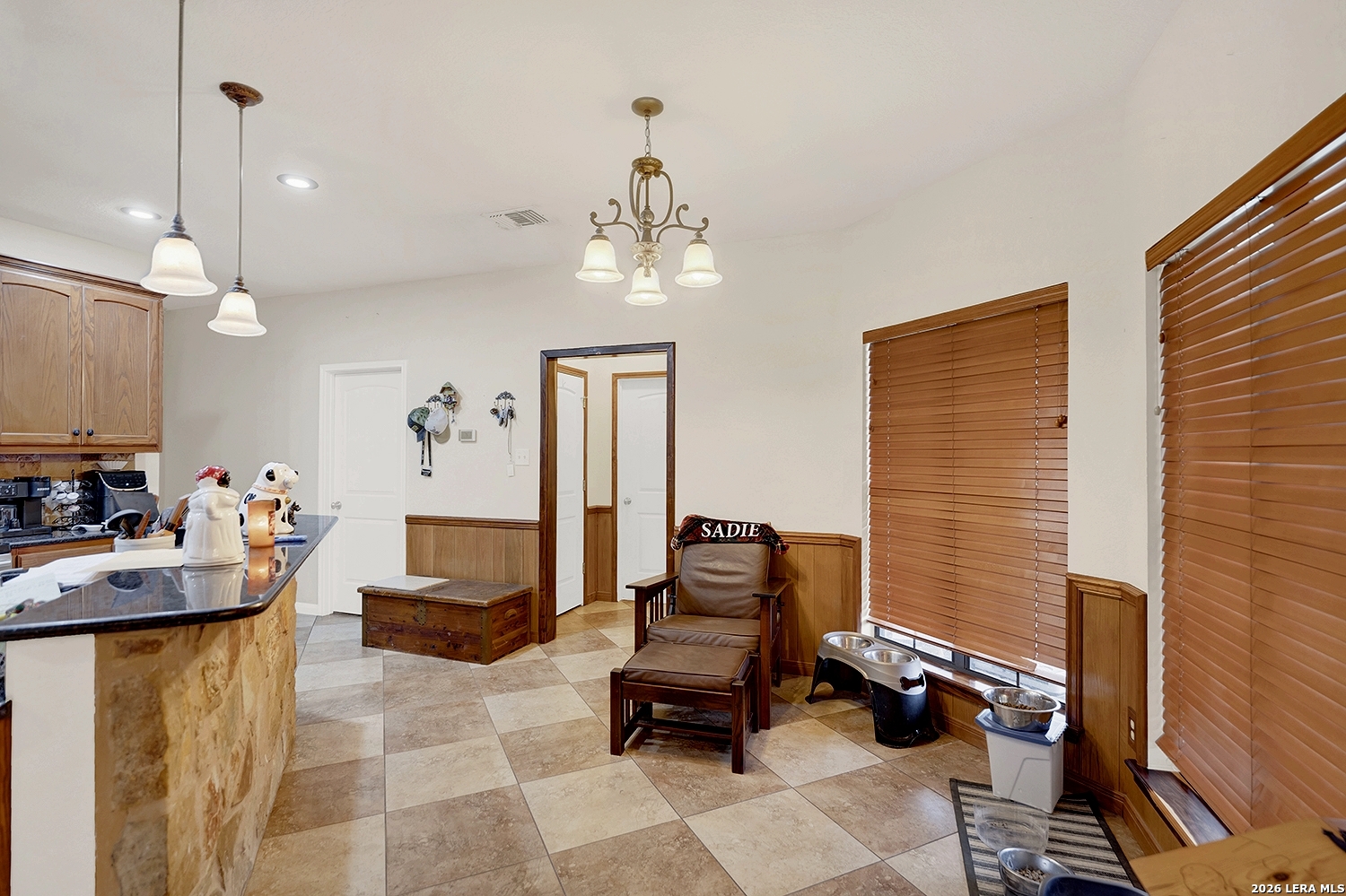 3283 Hartfield Road La Vernia, TX 78121 - Photo 12 of 40 a living room with furniture and a chandelier