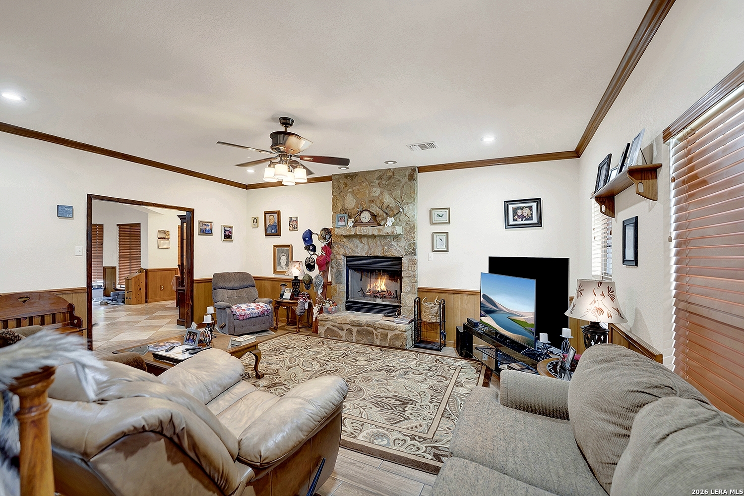 3283 Hartfield Road La Vernia, TX 78121 - Photo 15 of 40 a living room with furniture a fireplace and a flat screen tv