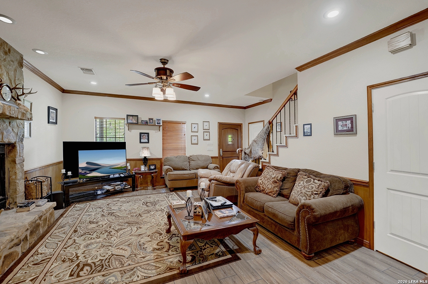 3283 Hartfield Road La Vernia, TX 78121 - Photo 18 of 40 a living room with furniture a fireplace and a flat screen tv