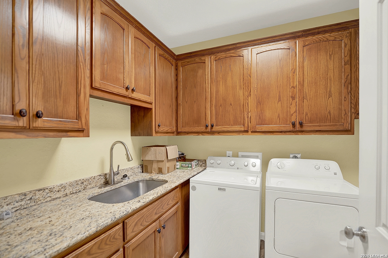 3283 Hartfield Road La Vernia, TX 78121 - Photo 20 of 40 a view of a sink and washer dryer