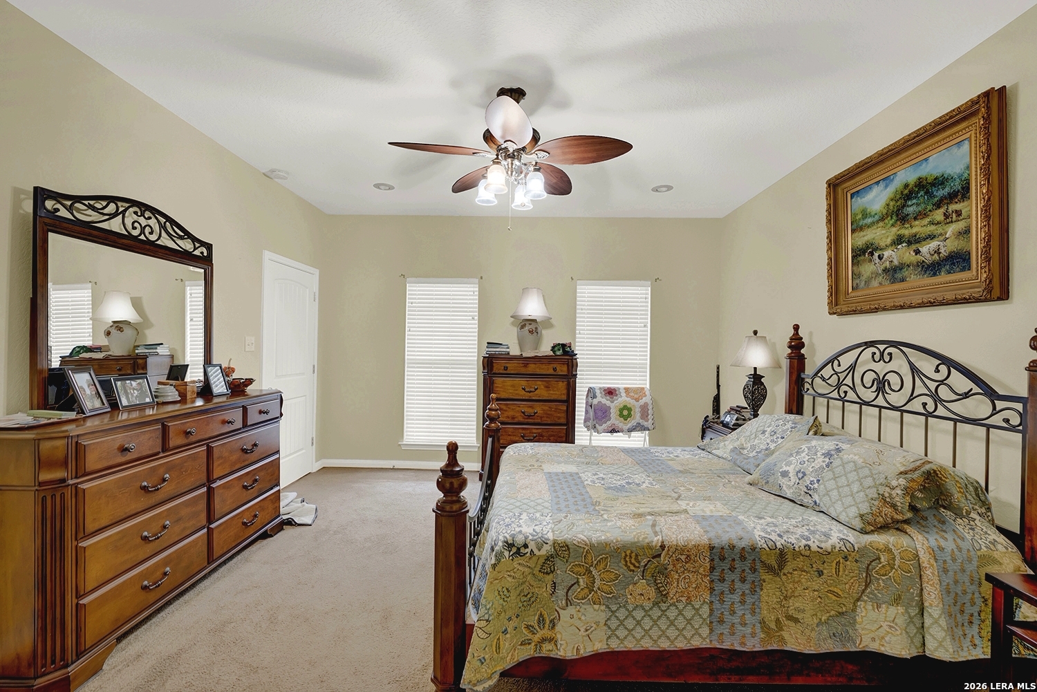 3283 Hartfield Road La Vernia, TX 78121 - Photo 23 of 40 a bedroom with a bed and a chandelier