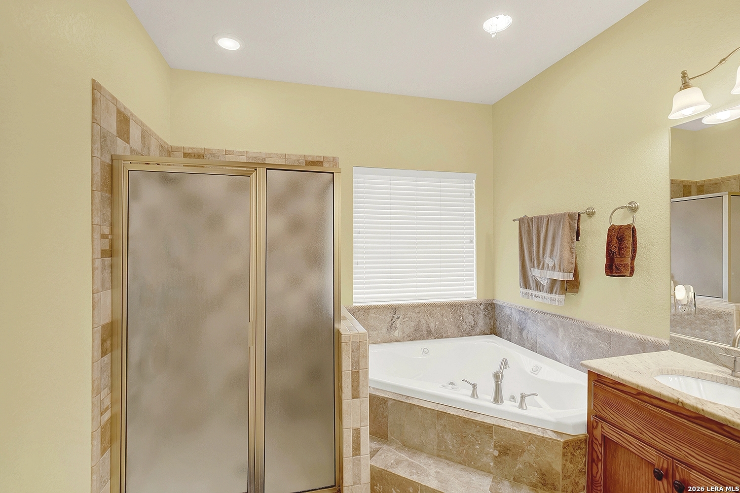 3283 Hartfield Road La Vernia, TX 78121 - Photo 25 of 40 a bathroom with a tub a sink and a shower
