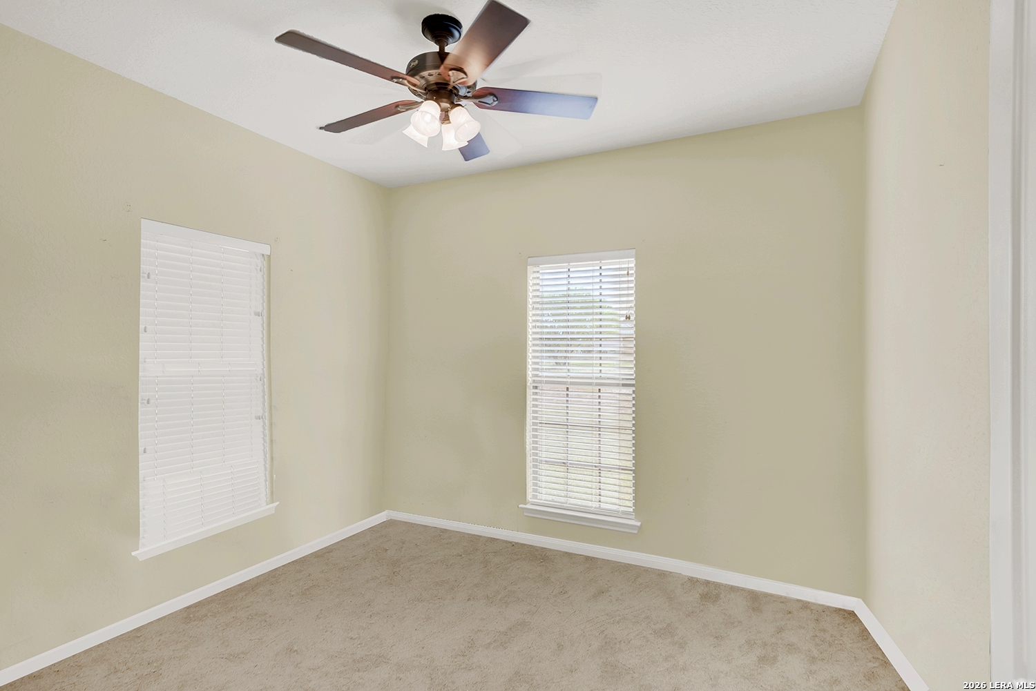 3283 Hartfield Road La Vernia, TX 78121 - Photo 27 of 40 an empty room with windows and fan