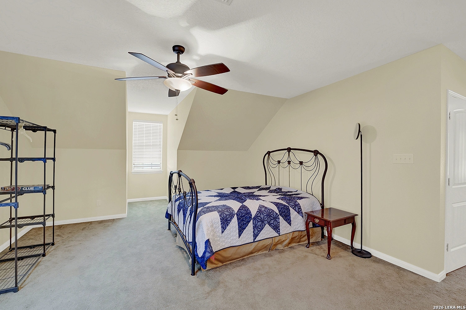 3283 Hartfield Road La Vernia, TX 78121 - Photo 32 of 40 a bedroom with a bed and a chandelier