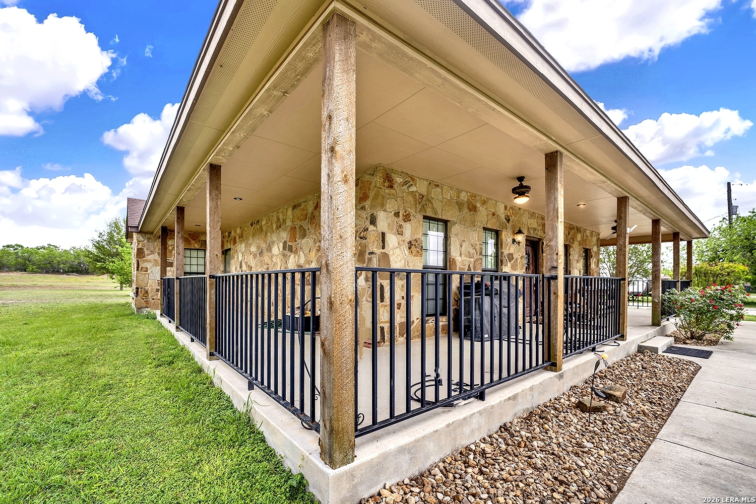 3283 Hartfield Road La Vernia, TX 78121 - Photo 6 of 40 a view of a brick house with a small yard
