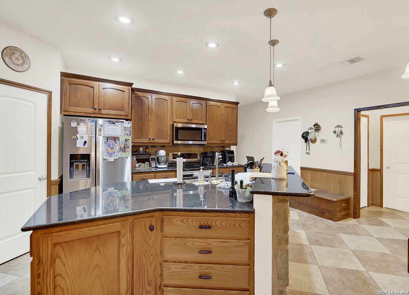 3283 Hartfield Road La Vernia, TX 78121 - Photo 8 of 40 a kitchen with stainless steel appliances granite countertop a sink refrigerator and cabinets