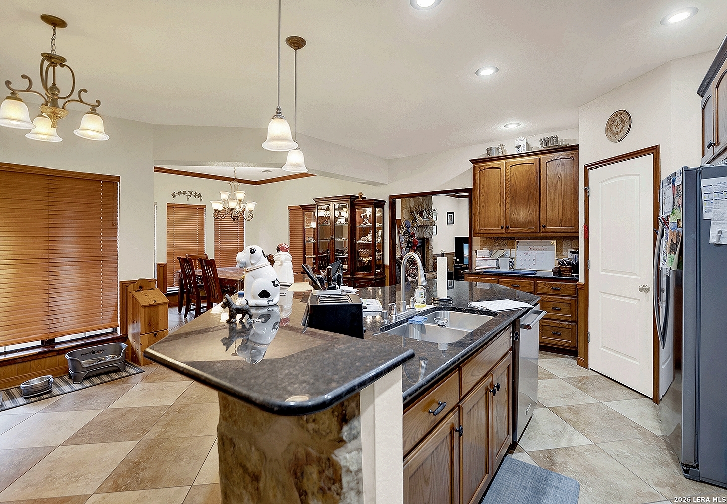 3283 Hartfield Road La Vernia, TX 78121 - Photo 10 of 40 a kitchen with stainless steel appliances granite countertop a sink a stove and refrigerator