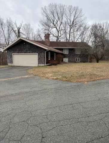 a house that has a tree in front of it