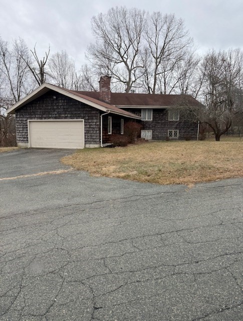 a house that has a tree in front of it