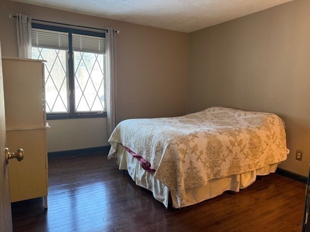 1 Bruce Street Avon, MA 02322 - Photo 12 of 23 a bedroom with a bed and wooden floor