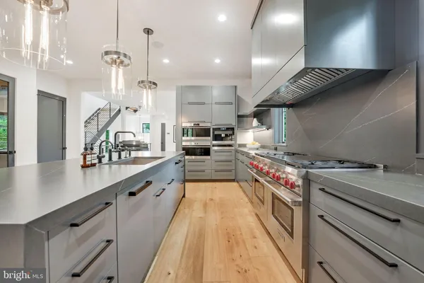 a large kitchen with stainless steel appliances granite countertop lots of counter space a sink and cabinets