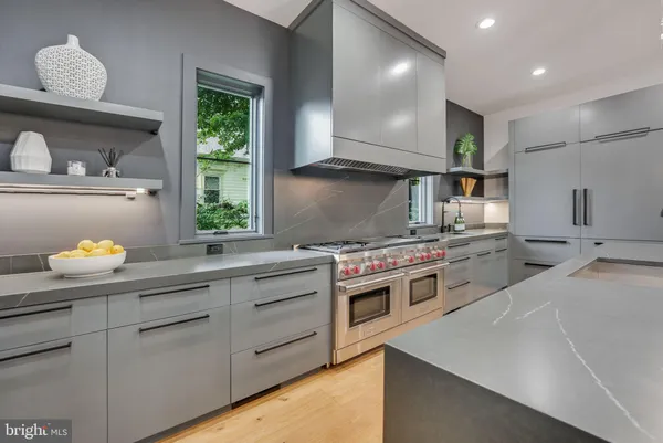a kitchen with stainless steel appliances a sink a stove and window