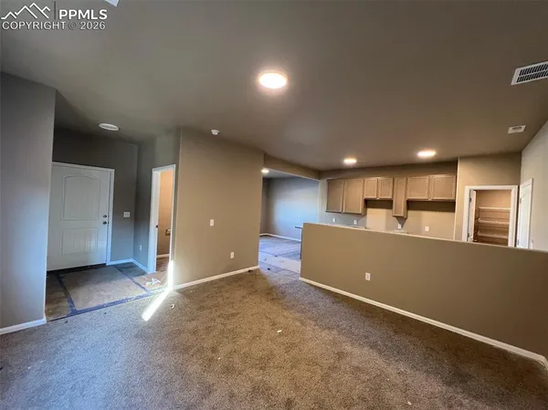 a kitchen with granite countertop a sink a stove and a wooden floor