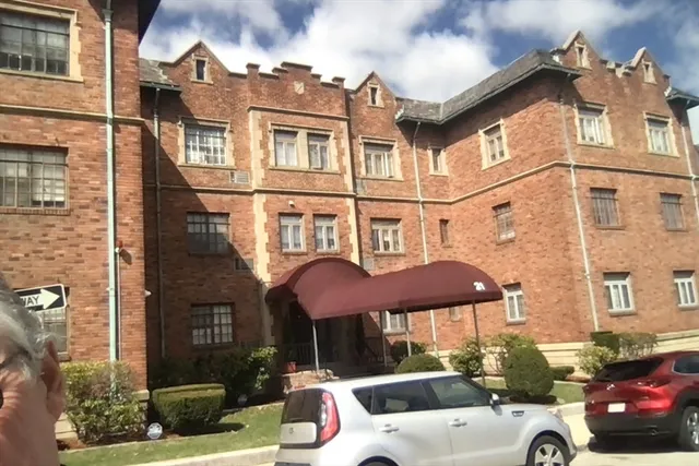 a front view of a building with parking space