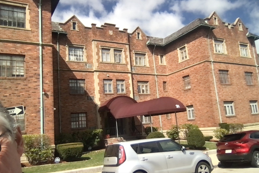 a front view of a building with parking space