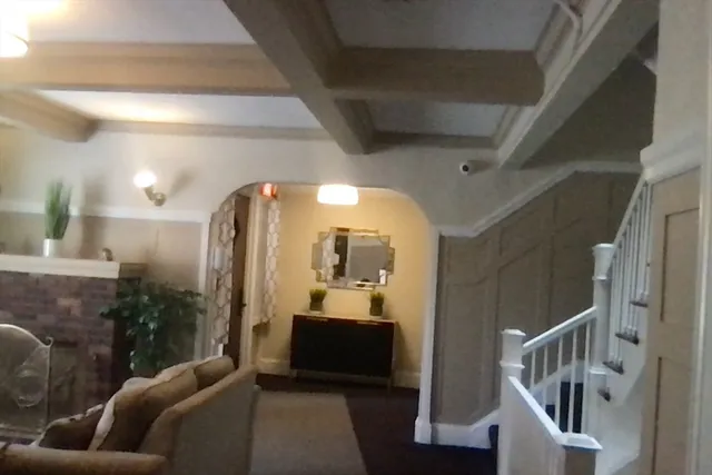 a living room with furniture and a mirror