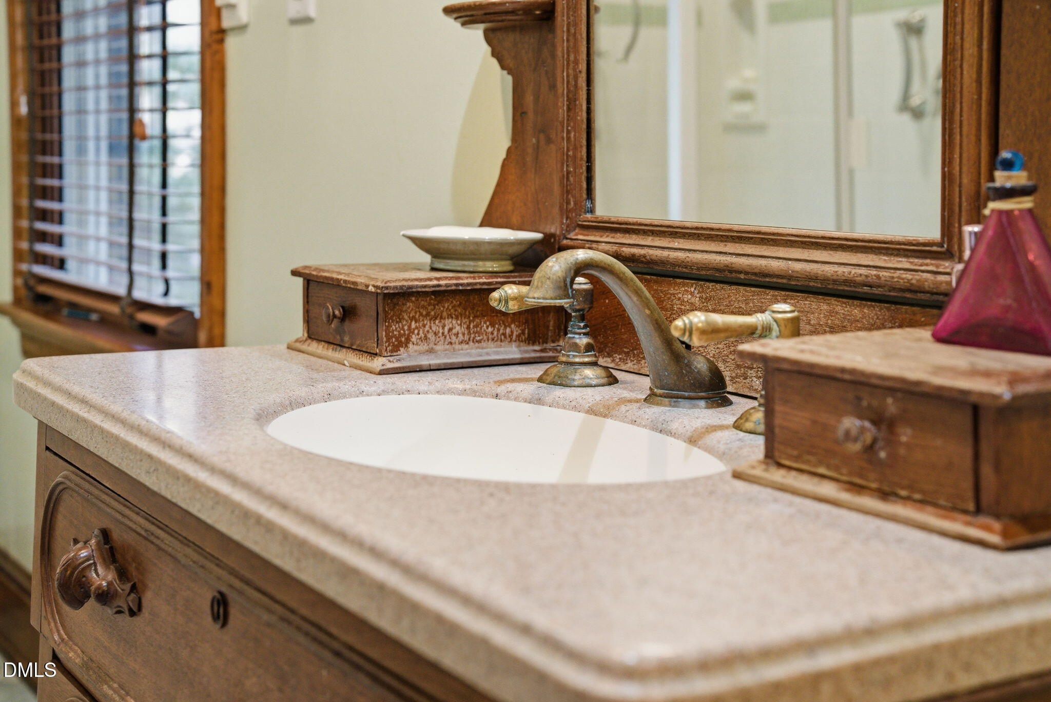 1513 Dellwood Drive Raleigh, NC 27607 - Photo 34 of 76 a bathroom with a sink and a mirror