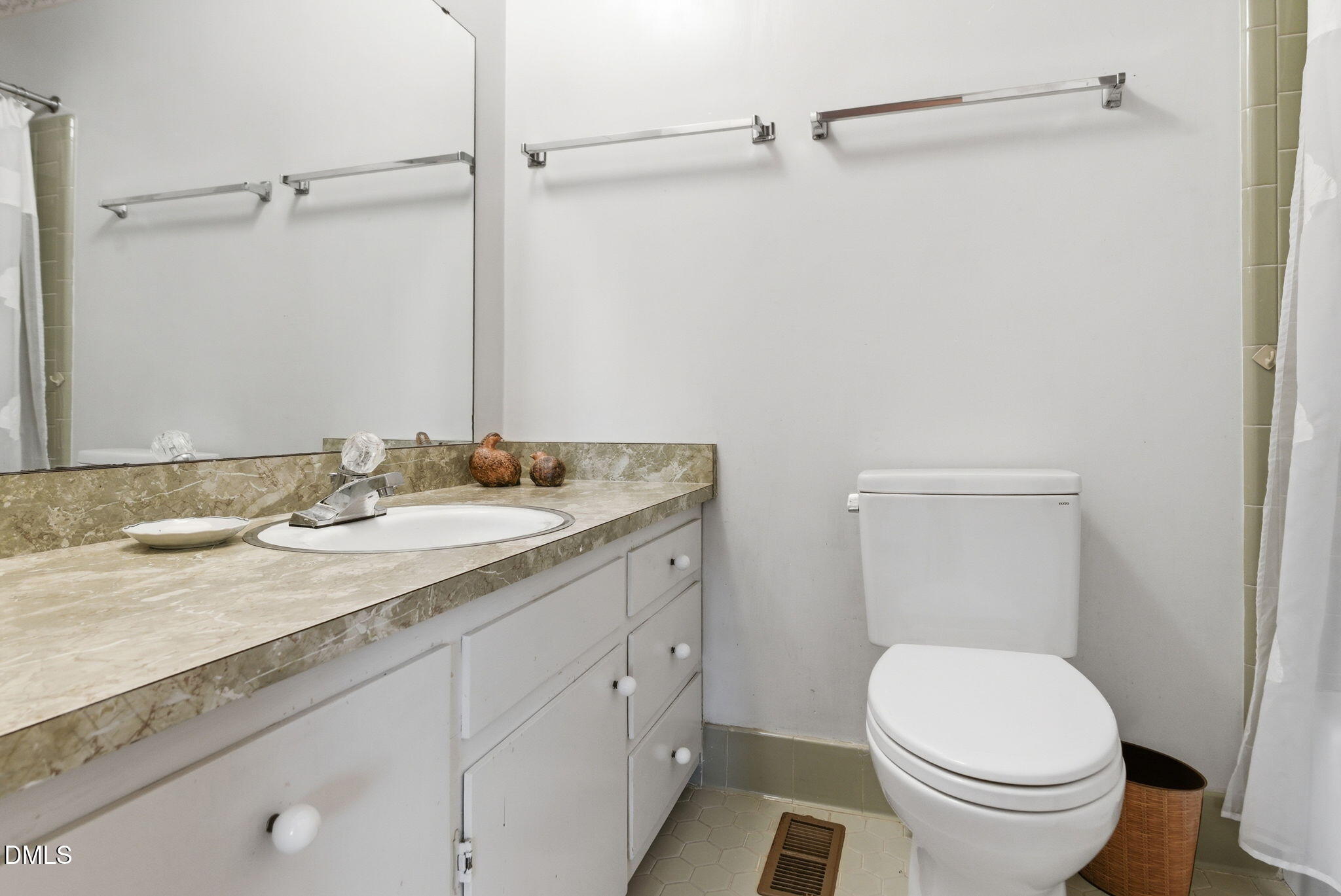 1513 Dellwood Drive Raleigh, NC 27607 - Photo 44 of 76 a bathroom with a granite countertop sink toilet and a mirror