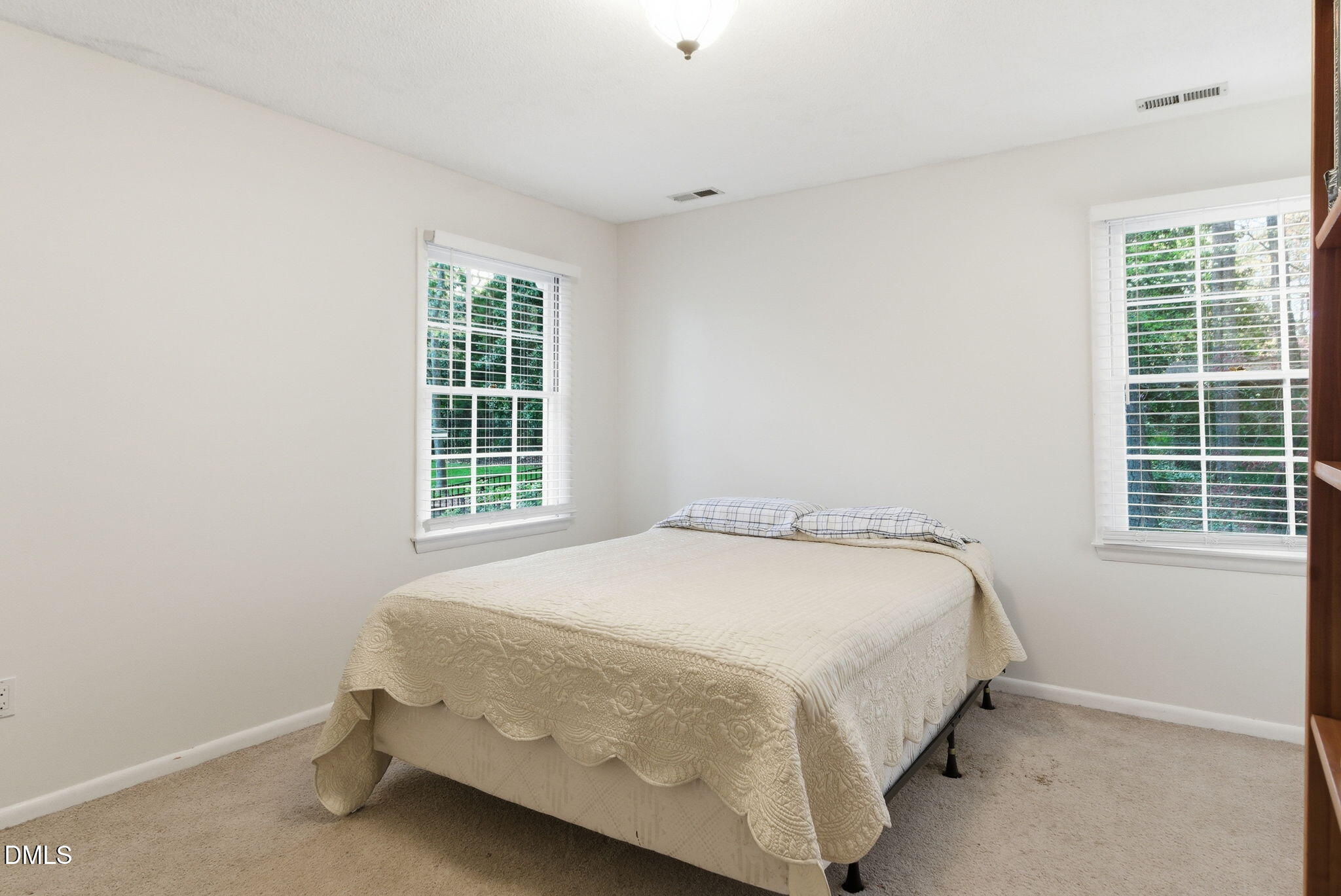 1513 Dellwood Drive Raleigh, NC 27607 - Photo 48 of 76 a bed sitting in a bedroom next to a window