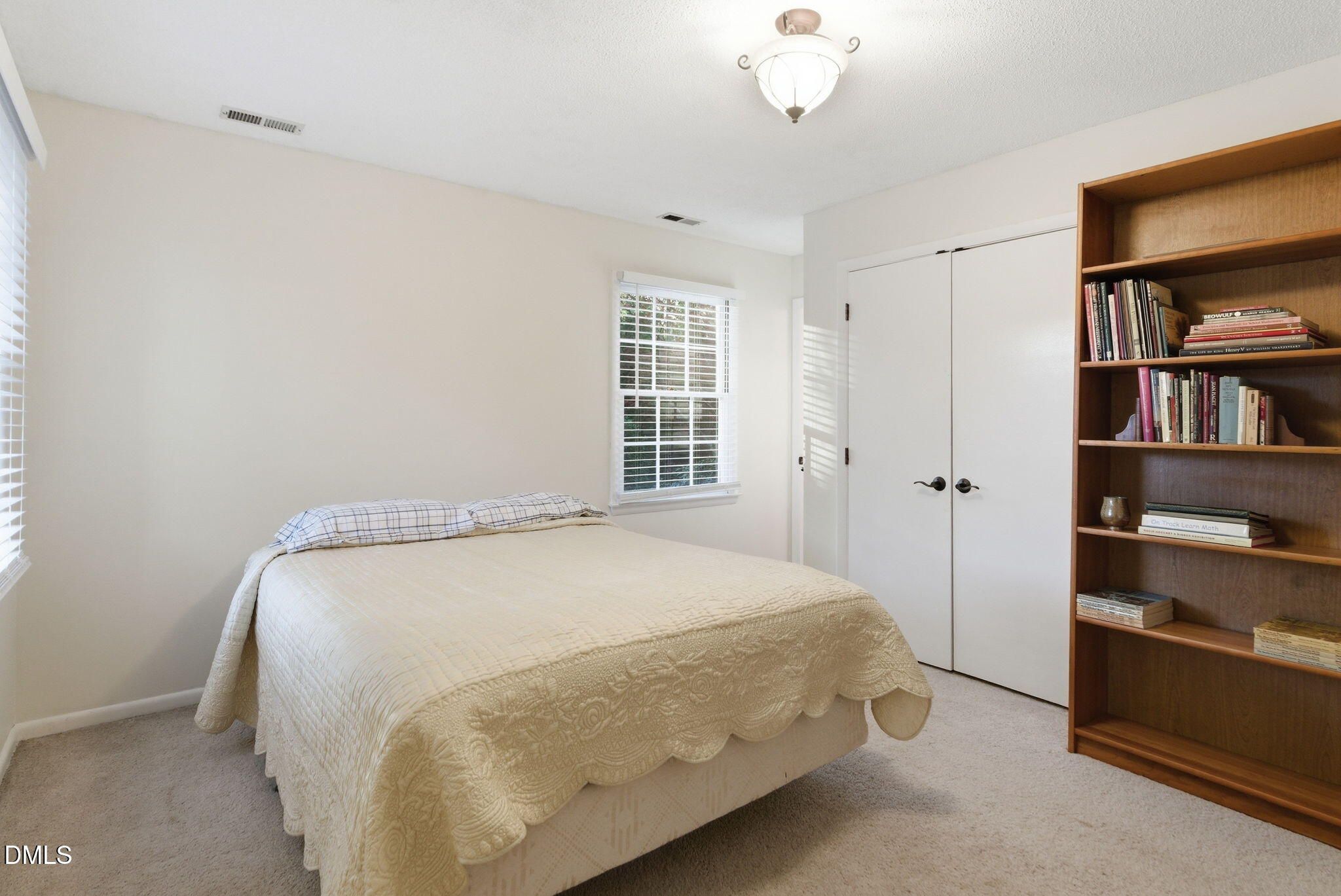 1513 Dellwood Drive Raleigh, NC 27607 - Photo 49 of 76 a bed sitting in a bedroom next to a window