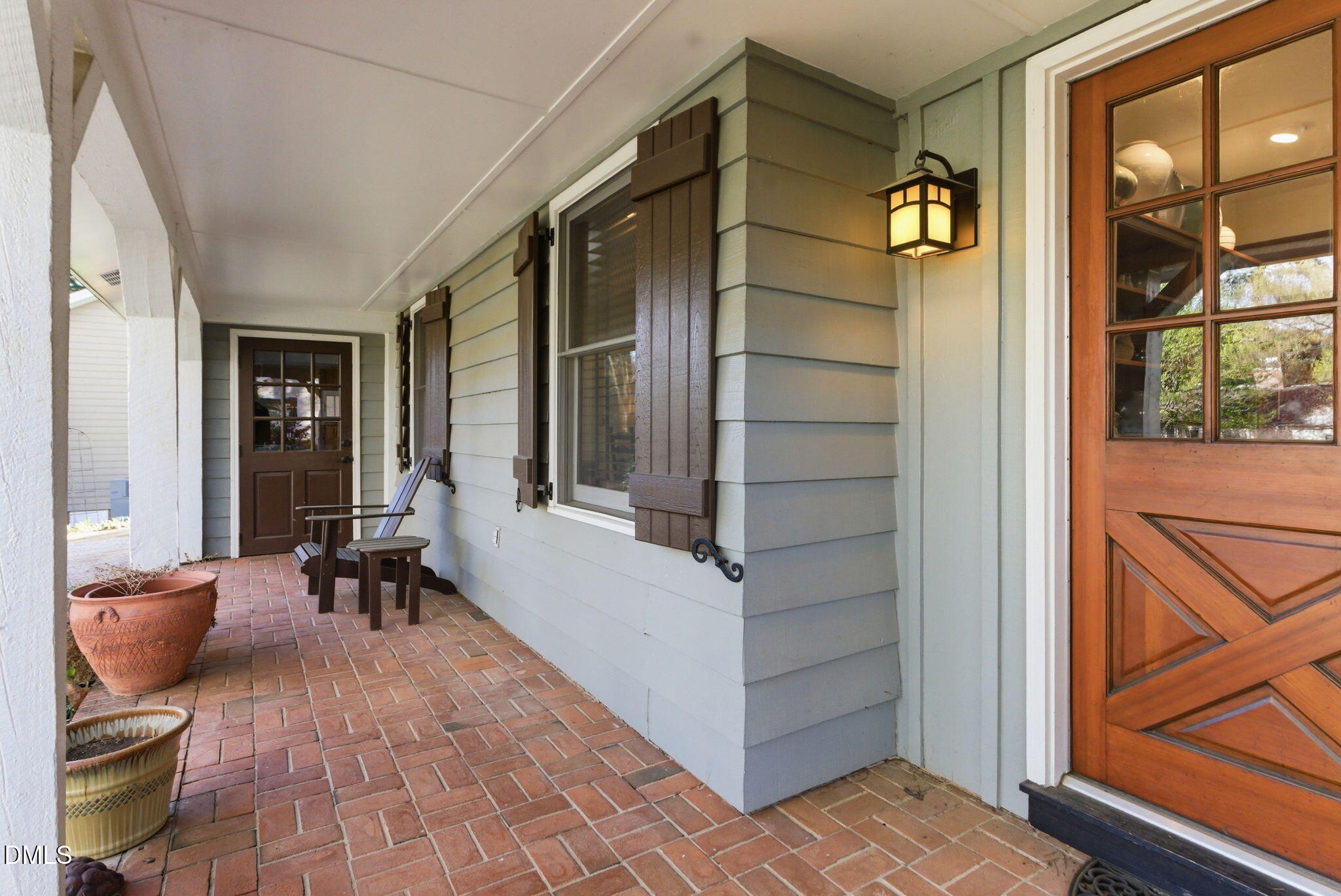 1513 Dellwood Drive Raleigh, NC 27607 - Photo 57 of 76 a view of a balcony with chair and the potted plant with wooden floor