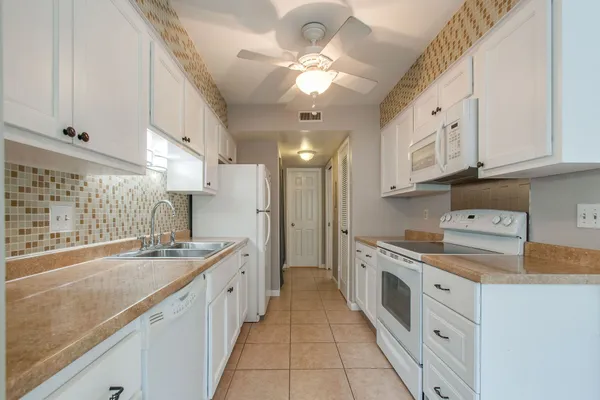 a kitchen with a sink cabinets and window