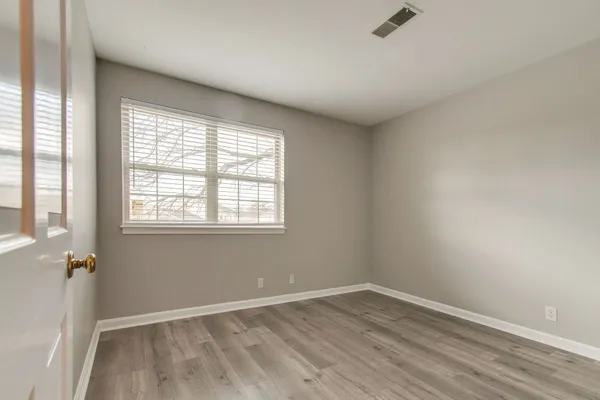 a view of a room with wooden floor