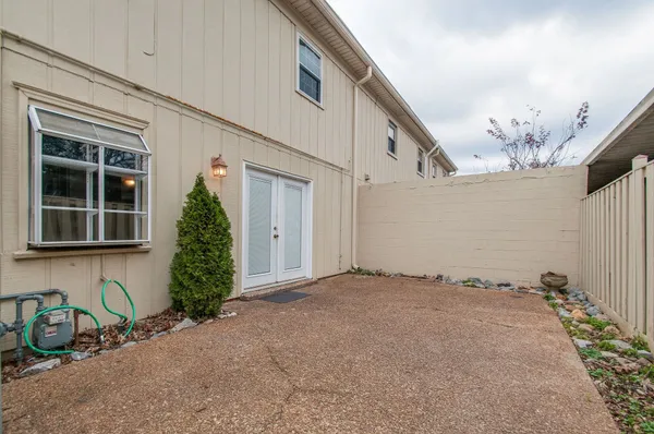 a front view of a house with a yard and glass windows