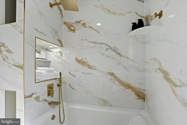 a bathroom with a granite countertop toilet sink and mirror