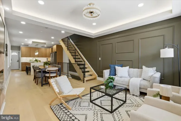 a living room with furniture and a view of kitchen