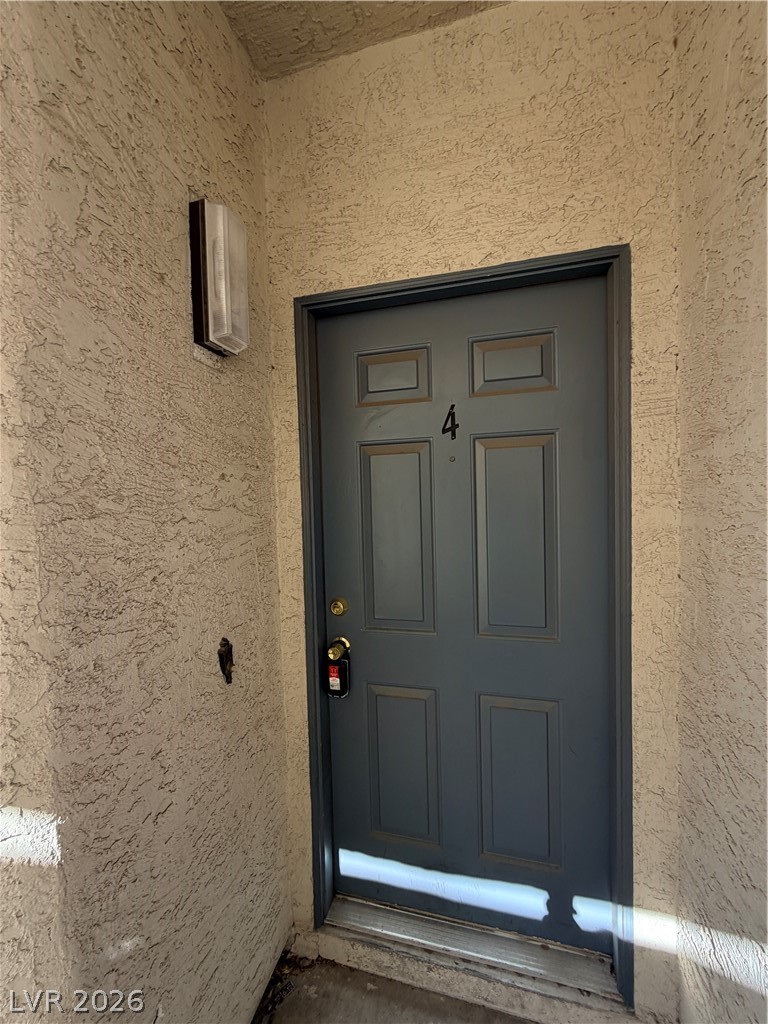 6250 West Flamingo Road, Unit 4 Las Vegas, NV 89103 - Photo 2 of 45 An inviting entrance awaits with a classic paneled door.