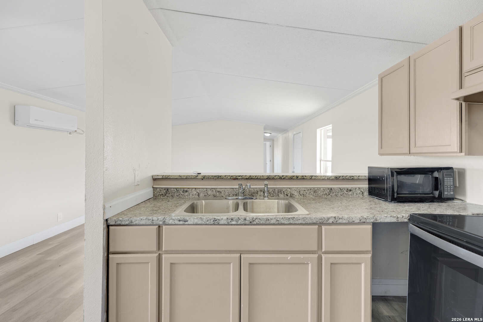 2811 County Road 467 Devine, TX 78016 - Photo 12 of 28 a kitchen with granite countertop a sink a stove and cabinets