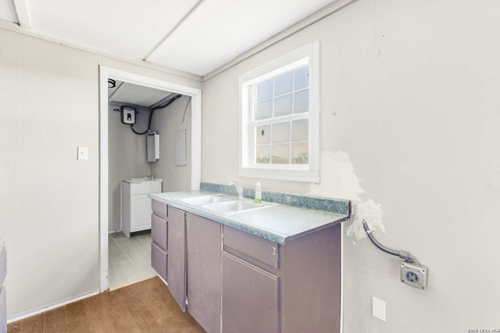 2811 County Road 467 Devine, TX 78016 - Photo 19 of 28 a bathroom with a granite countertop sink and a mirror