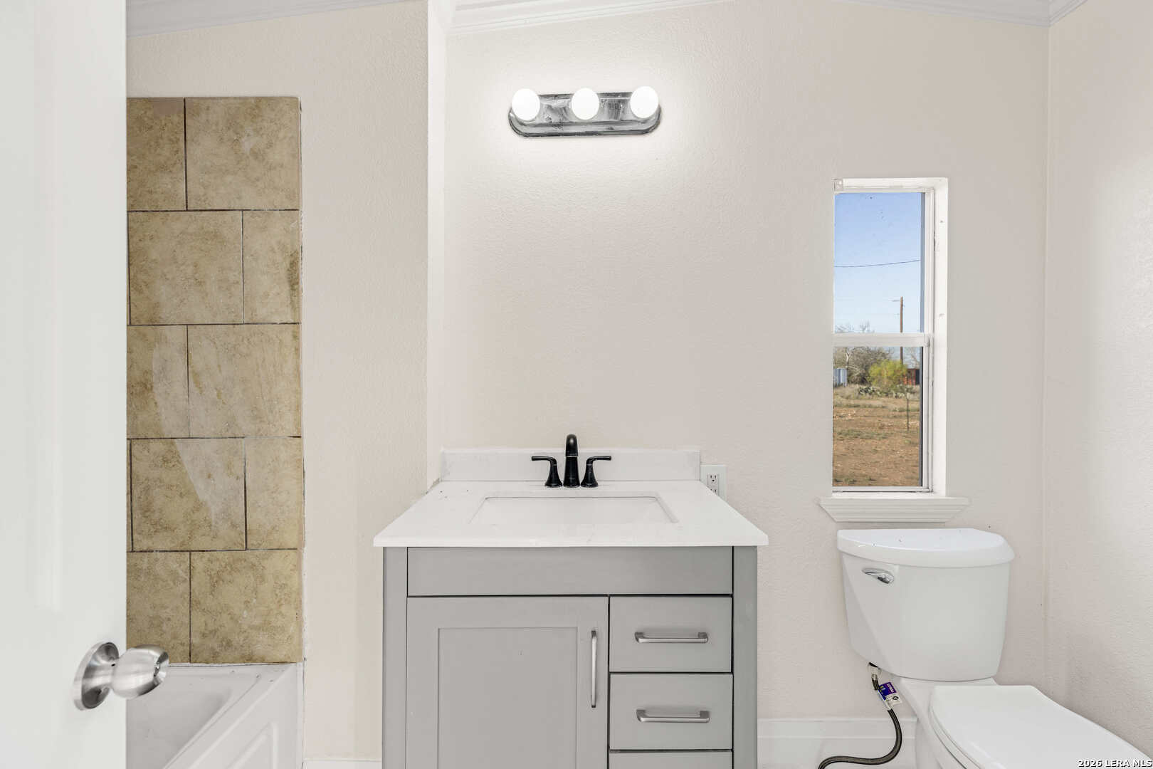 2811 County Road 467 Devine, TX 78016 - Photo 20 of 28 a bathroom with a sink a toilet and a mirror