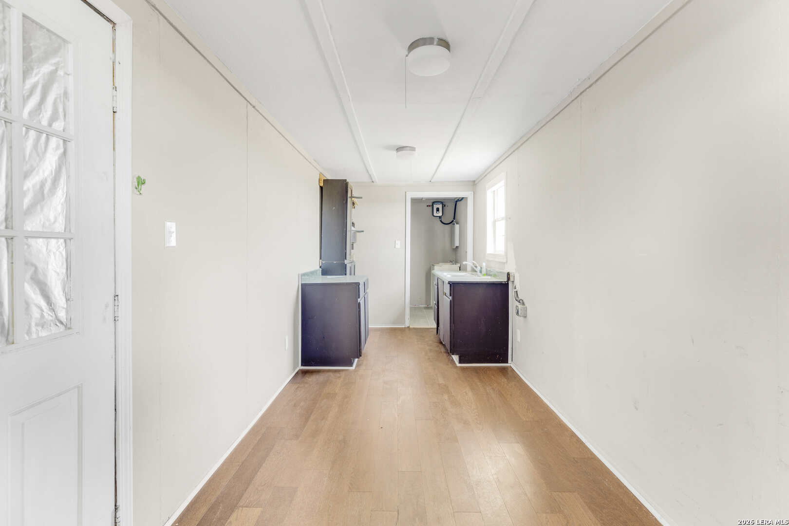 2811 County Road 467 Devine, TX 78016 - Photo 24 of 28 a view of a big room with a windows and a ceiling fan