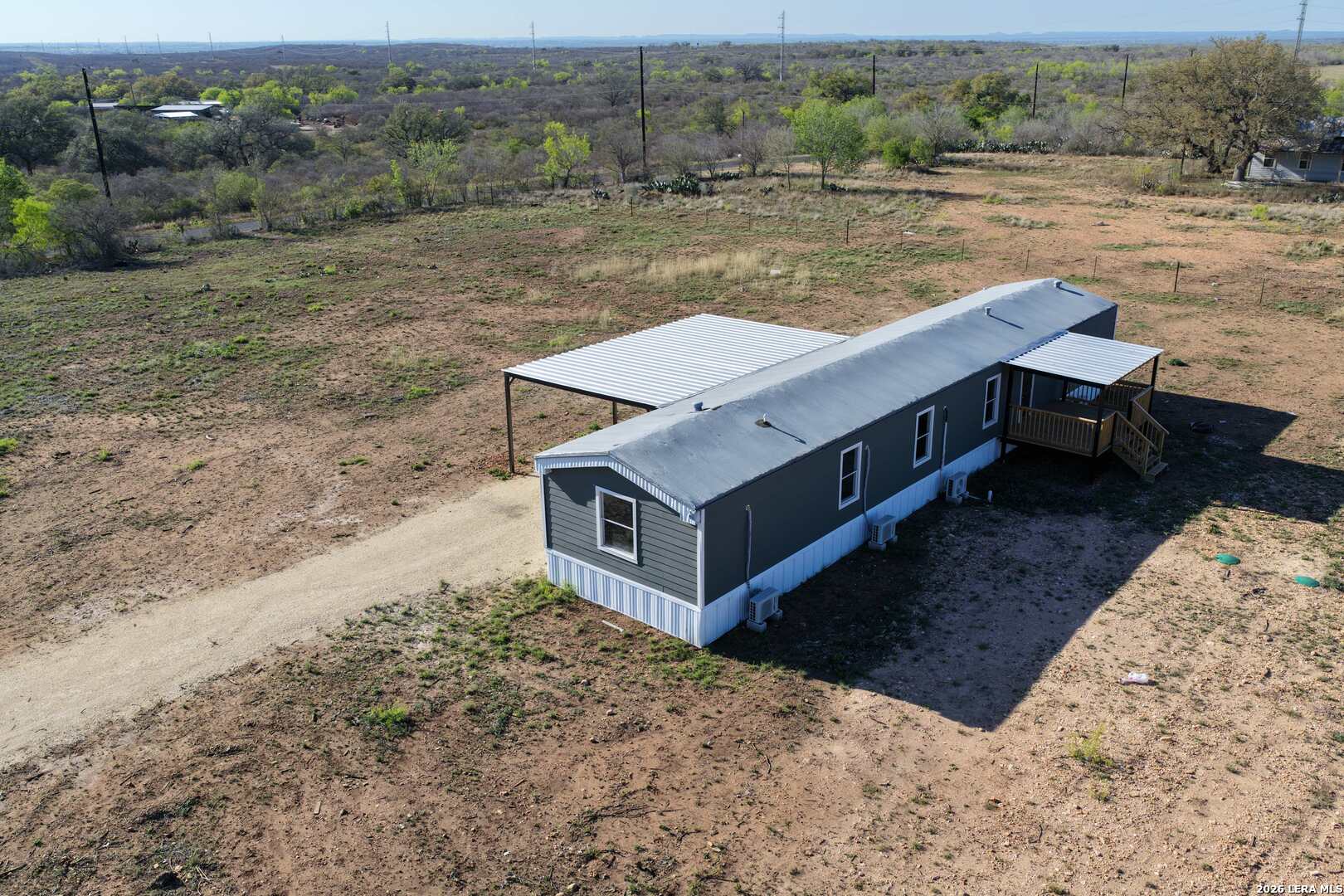 2811 County Road 467 Devine, TX 78016 - Photo 3 of 28 a view of a wooden deck and yard