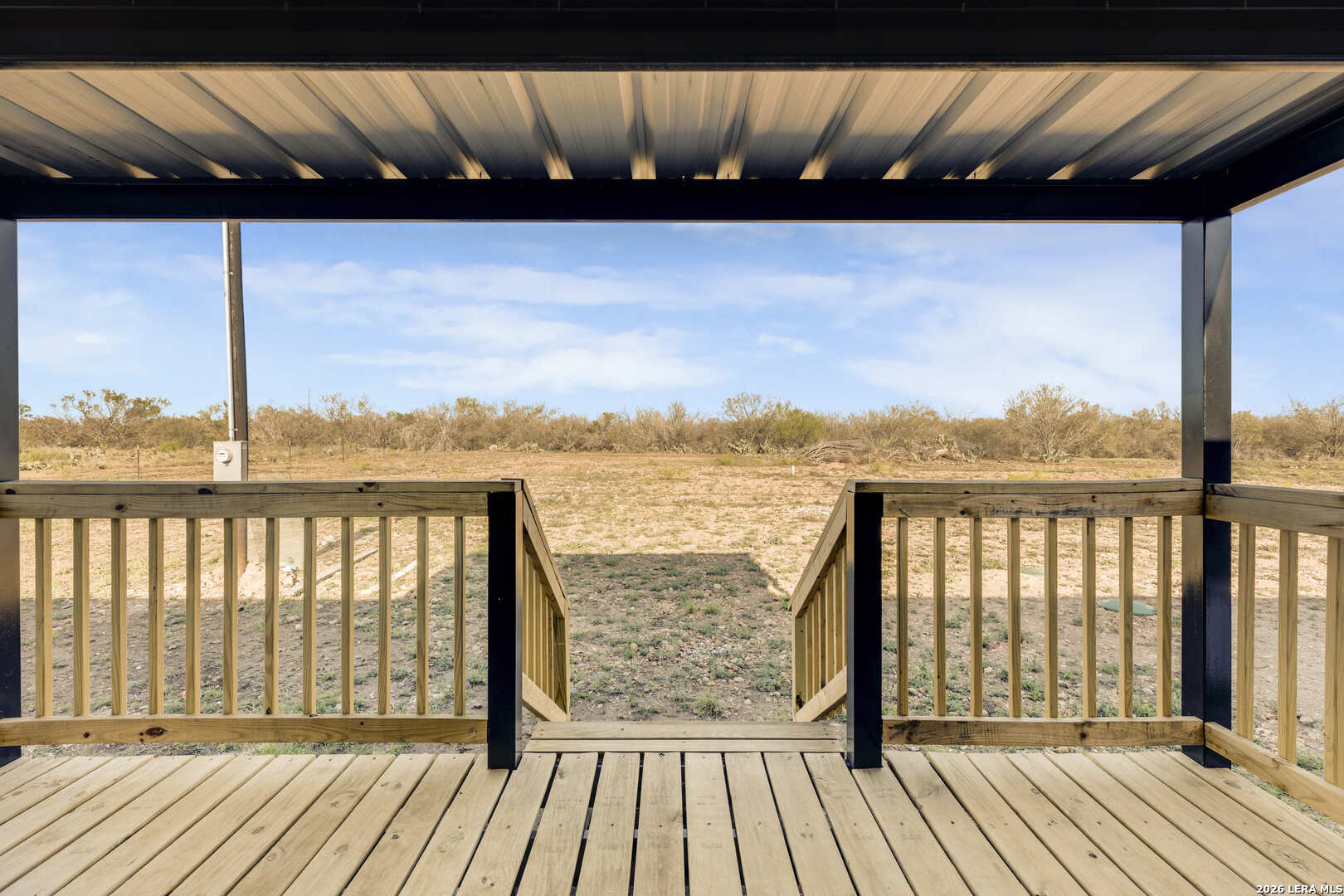 2811 County Road 467 Devine, TX 78016 - Photo 9 of 28 a balcony with wooden floor