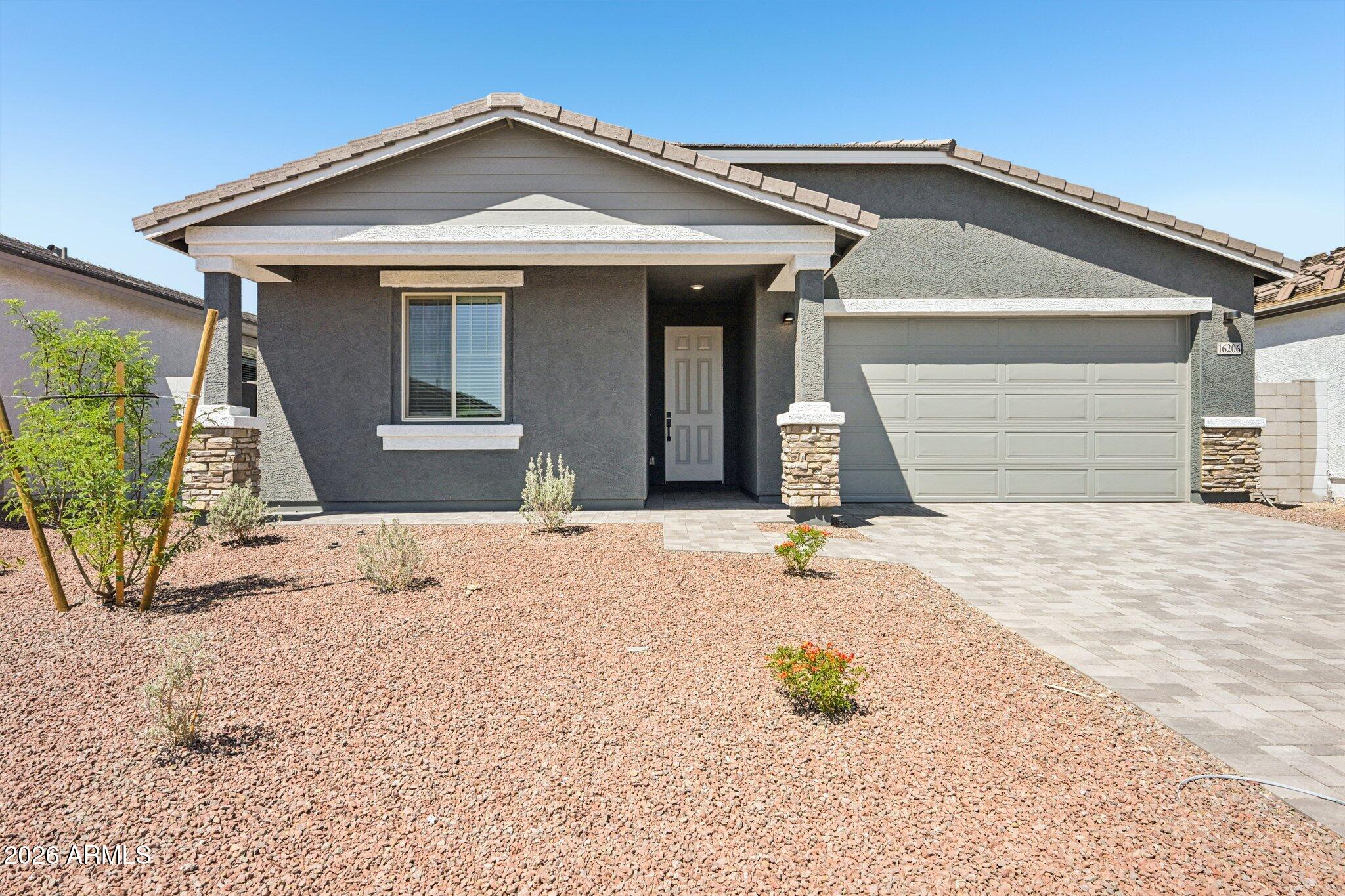16206 West Red Bird Road Surprise, AZ 85387 - Photo 2 of 35 a front view of a house with a outdoor space