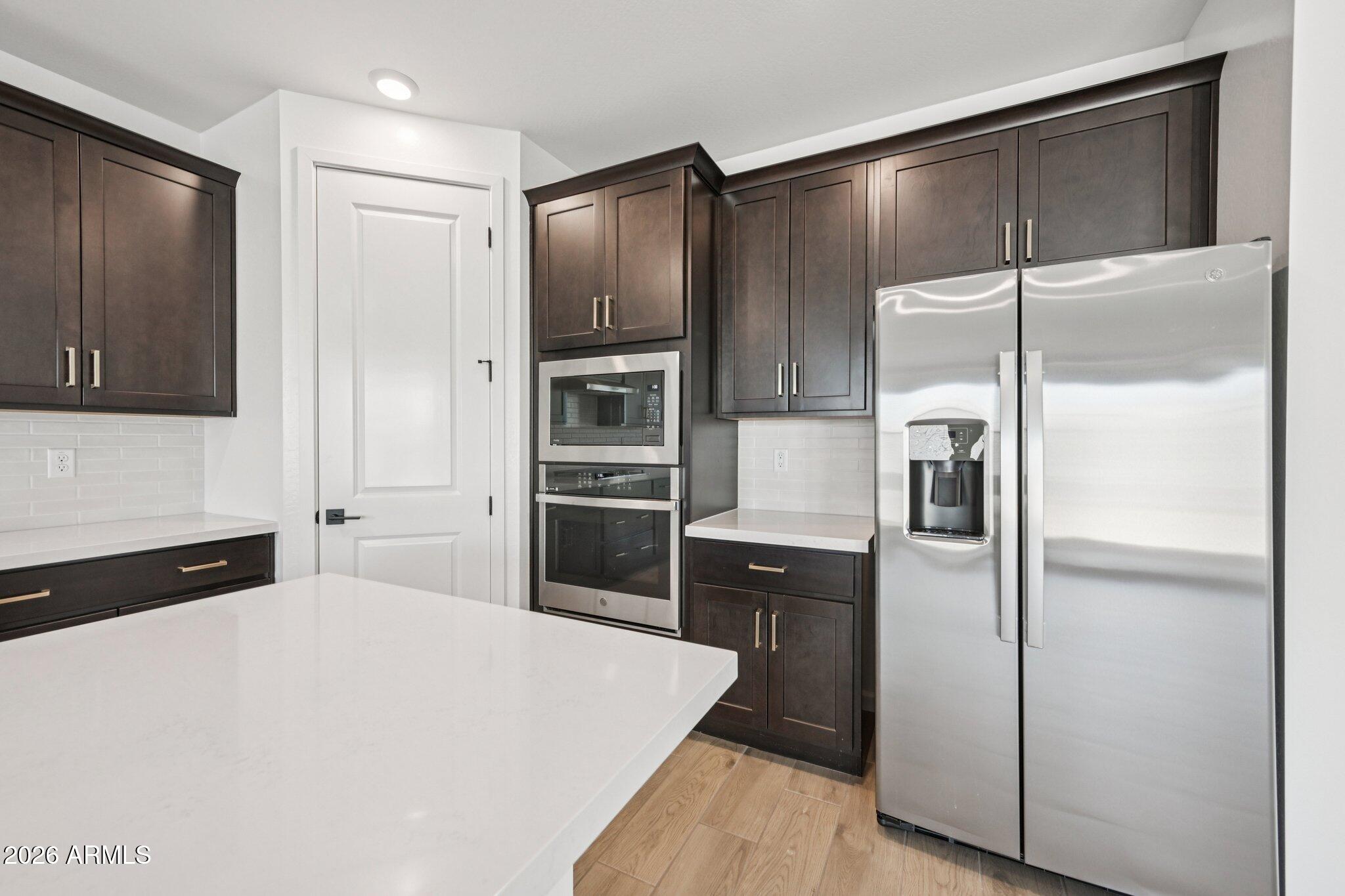 16206 West Red Bird Road Surprise, AZ 85387 - Photo 6 of 35 a kitchen with a refrigerator and a refrigerator