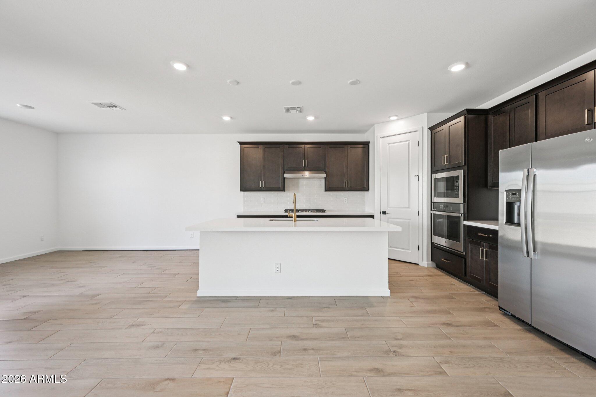16206 West Red Bird Road Surprise, AZ 85387 - Photo 9 of 35 a view of kitchen with microwave and cabinets