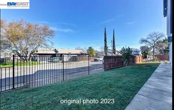 a view of a backyard with wooden fence