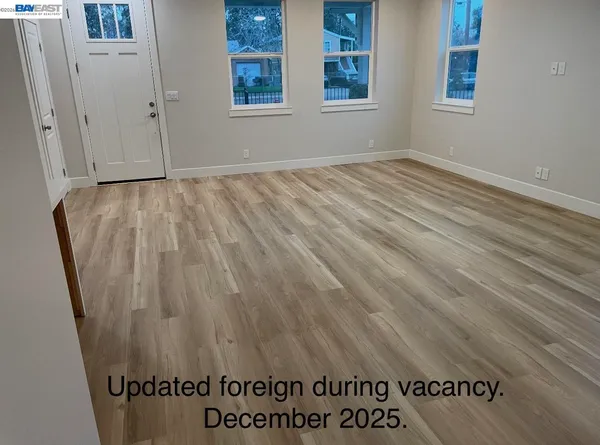 an empty room with wooden floor