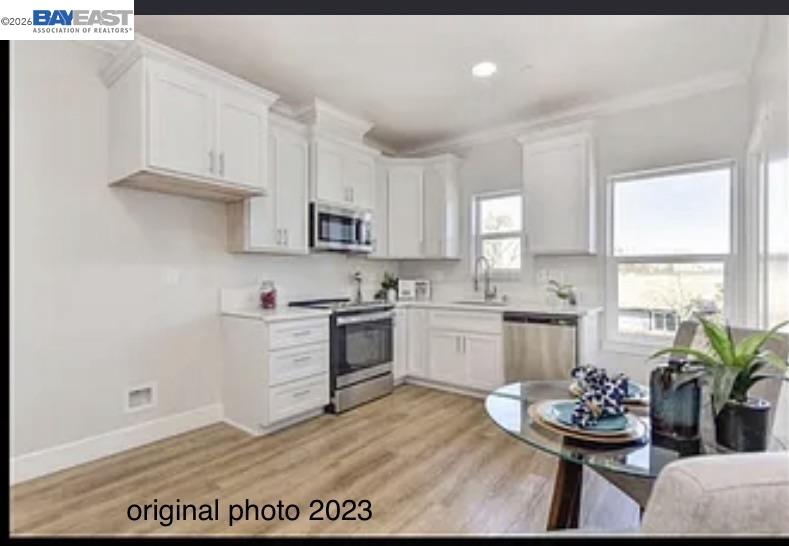 3334 Rio Linda Boulevard Sacramento, CA 95838 - Photo 27 of 31 a kitchen with white cabinets and stove
