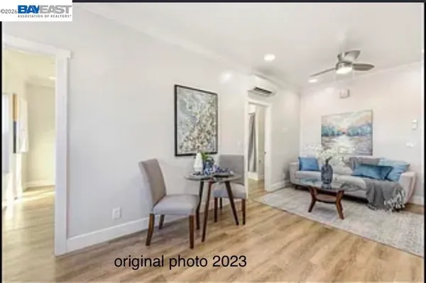 a view of a livingroom with furniture window and wooden floor