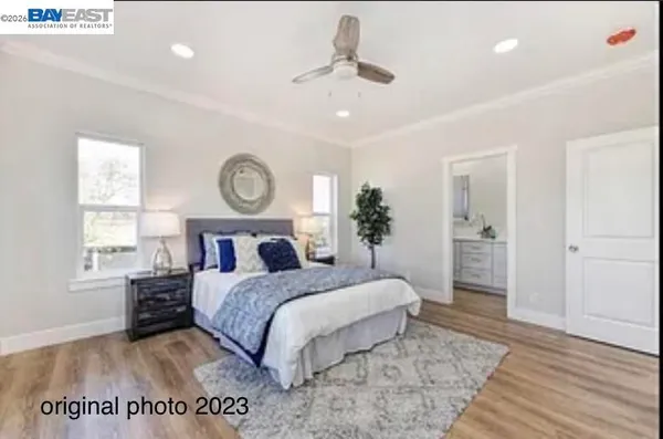 a bedroom with a large bed and a window