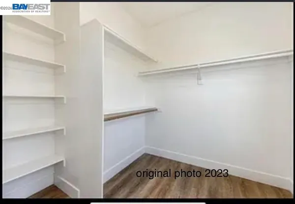 a view of walk in closet with empty racks