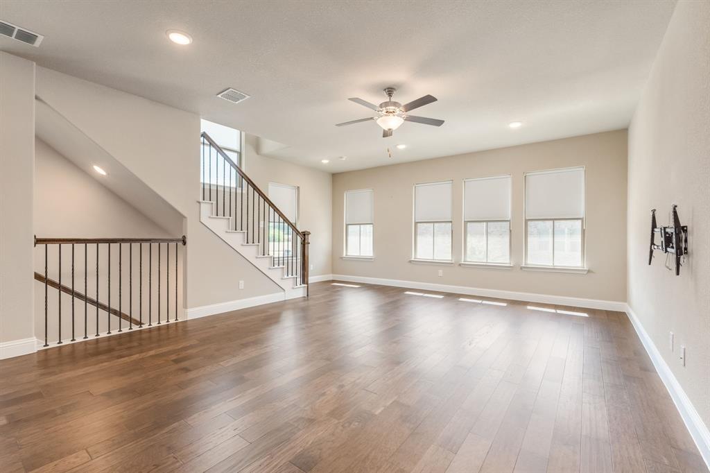 801 Cassandra Court Euless, TX 76040 - Photo 13 of 36 a view of an empty room with wooden floor and a window